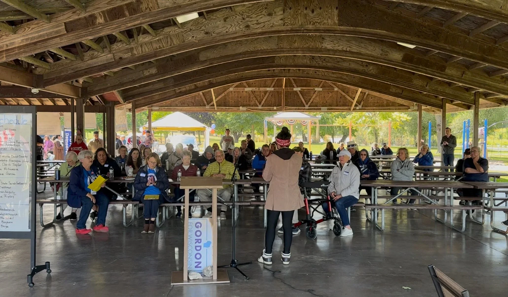 Francesca Hong for Governor of Wisconsin speaking at an event in a park.